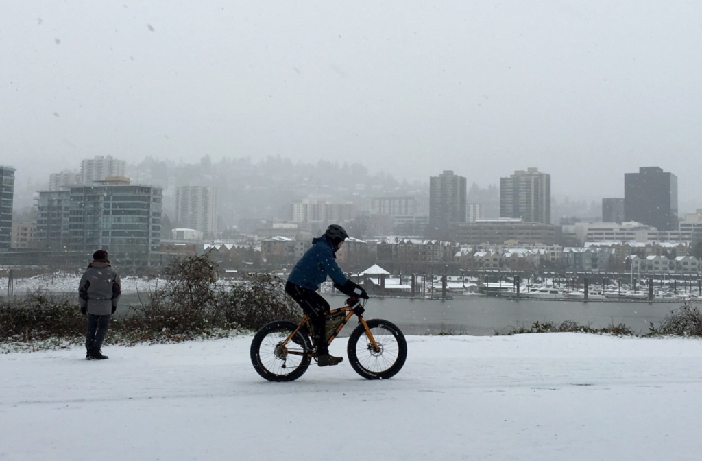 man riding a bike in portland snow